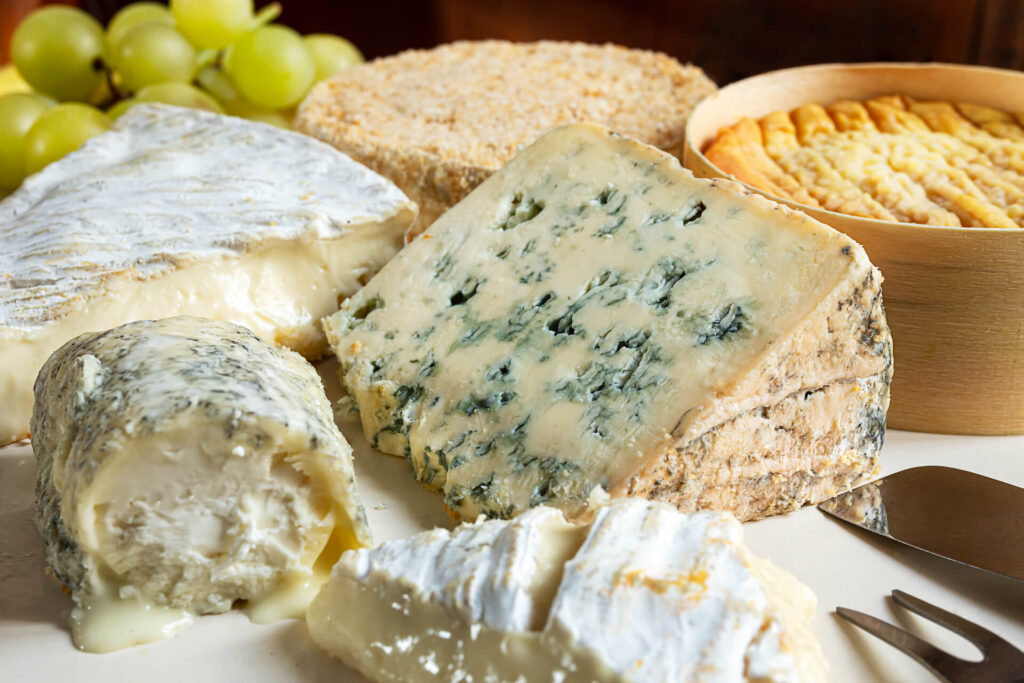 Assortment of French cheeses with grapes